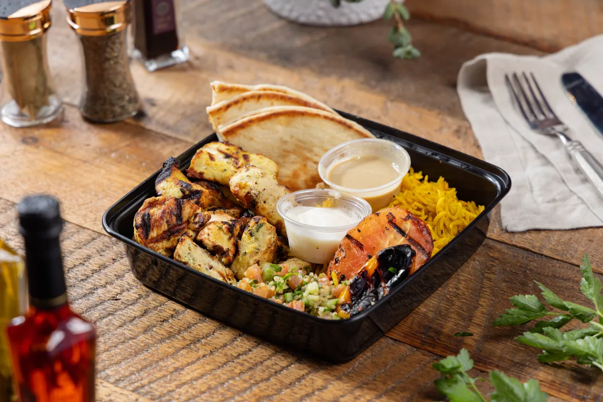 Fire-grilled chicken kabob plate with saffron rice from Ikaria Kitchen