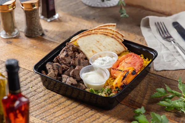 Grilled Mediterranean lamb kabob plate from Ikaria Kitchen