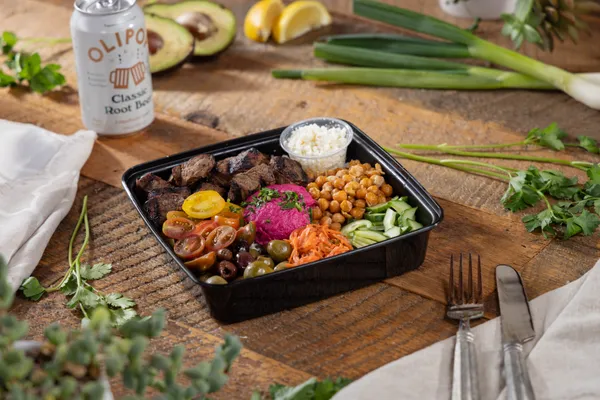 Mediterranean bowl with hummus, feta, and fresh vegetables from Ikaria Kitchen