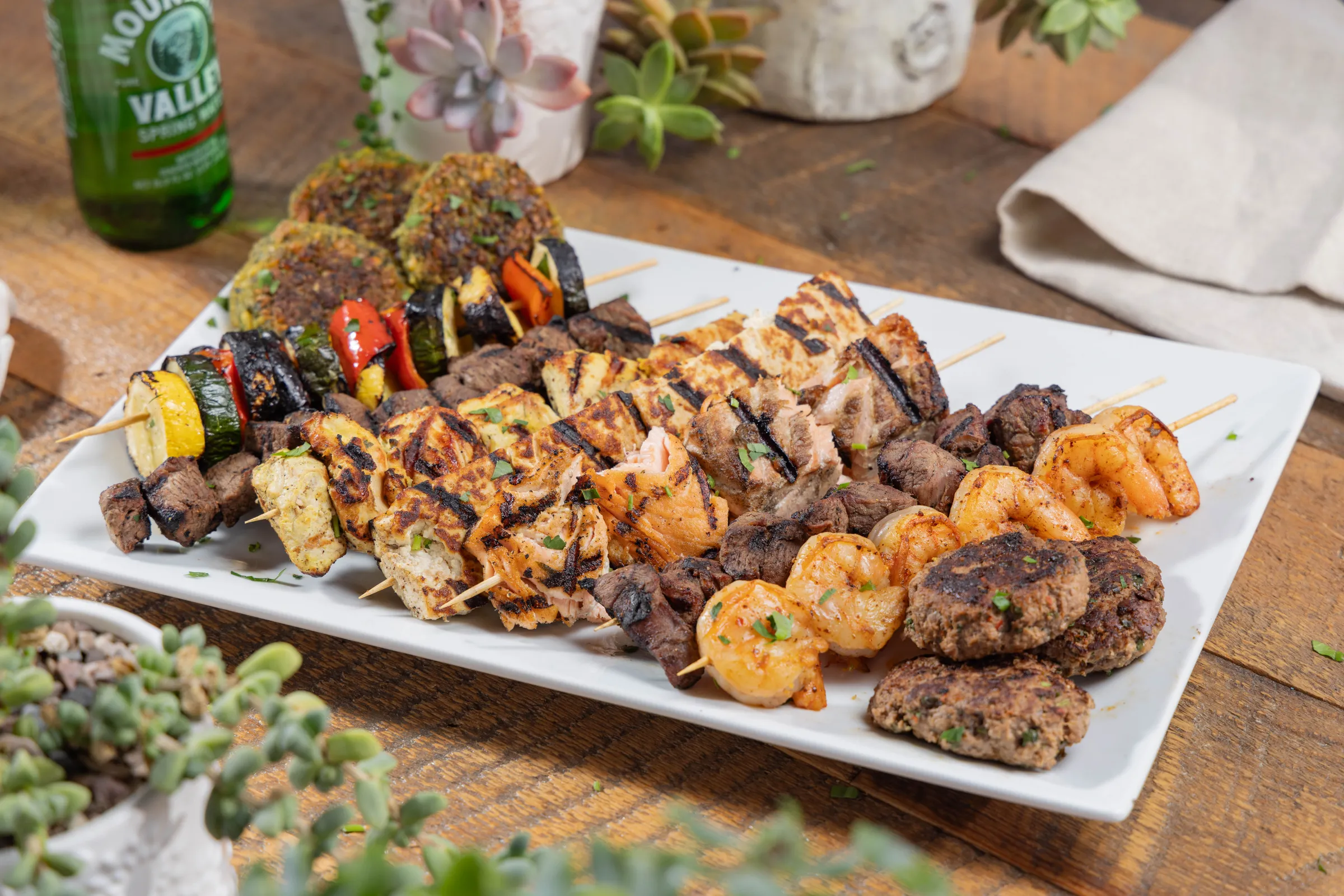 Grilled kabob platter with chicken, steak, and shrimp skewers from Ikaria Kitchen